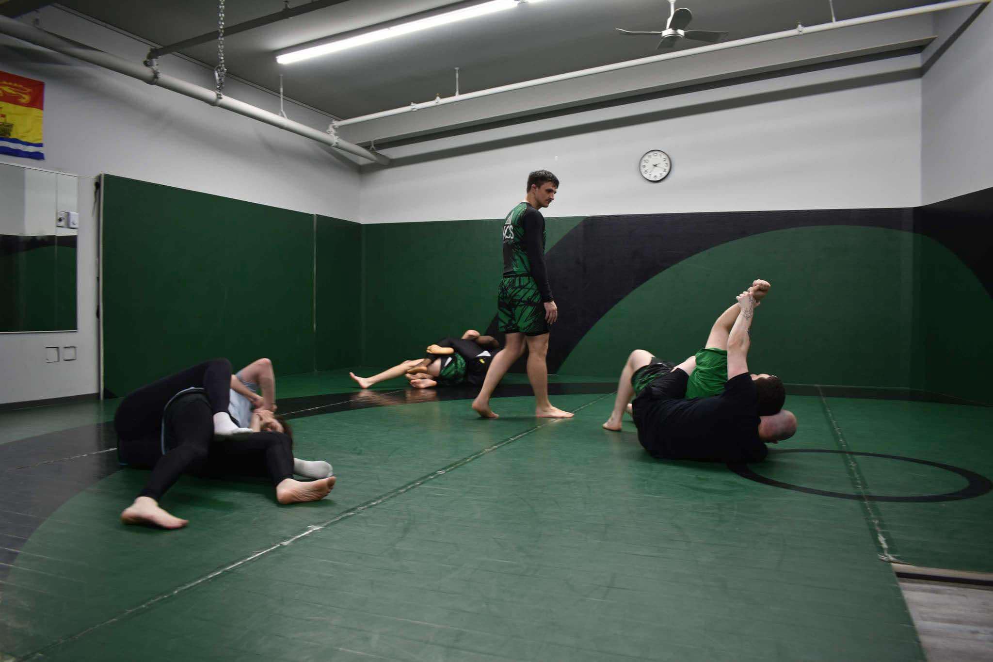 King Combat Sports class practicing grappling on the mat