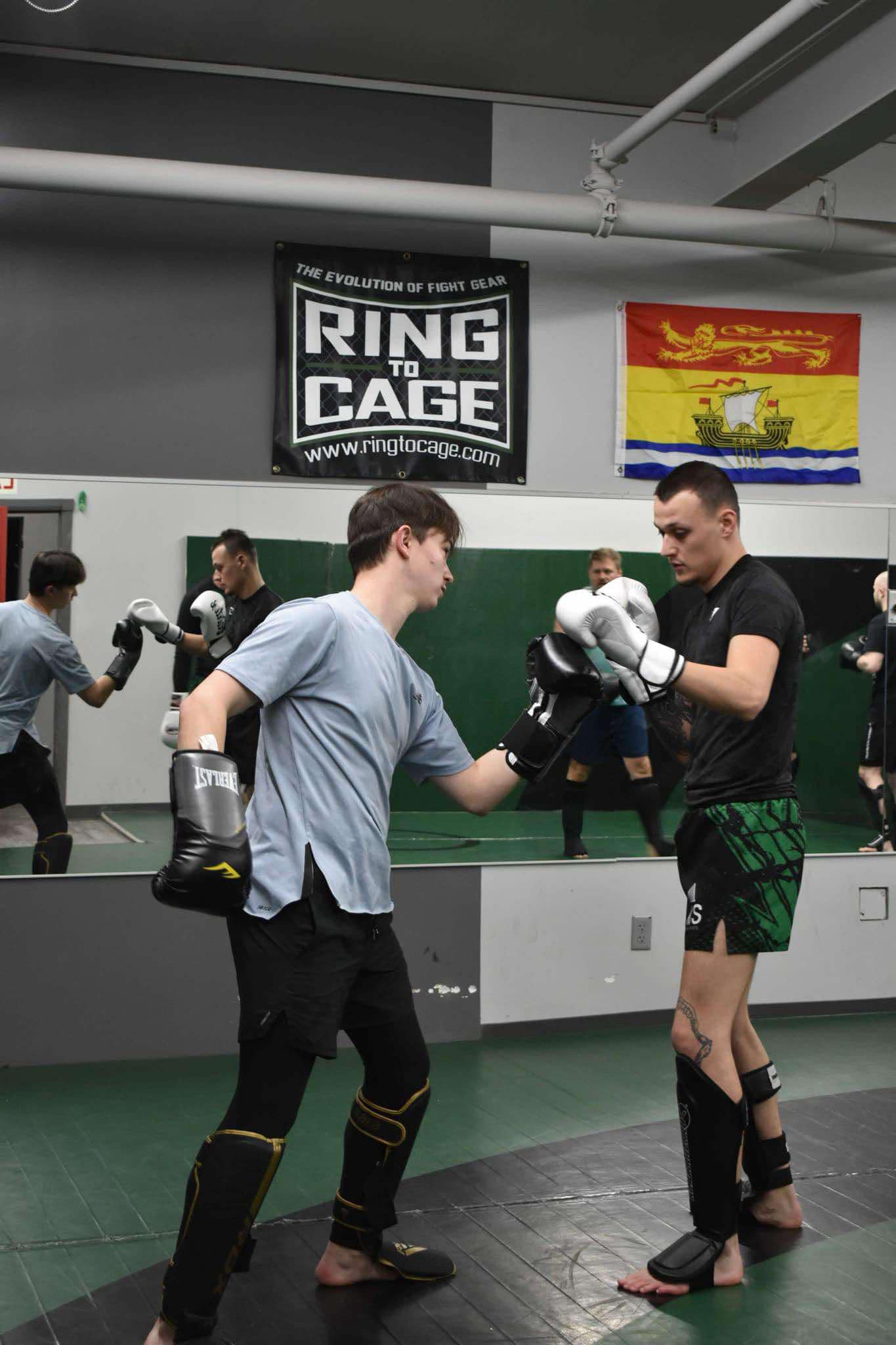King Combat Sports students with boxing gloves on the mat