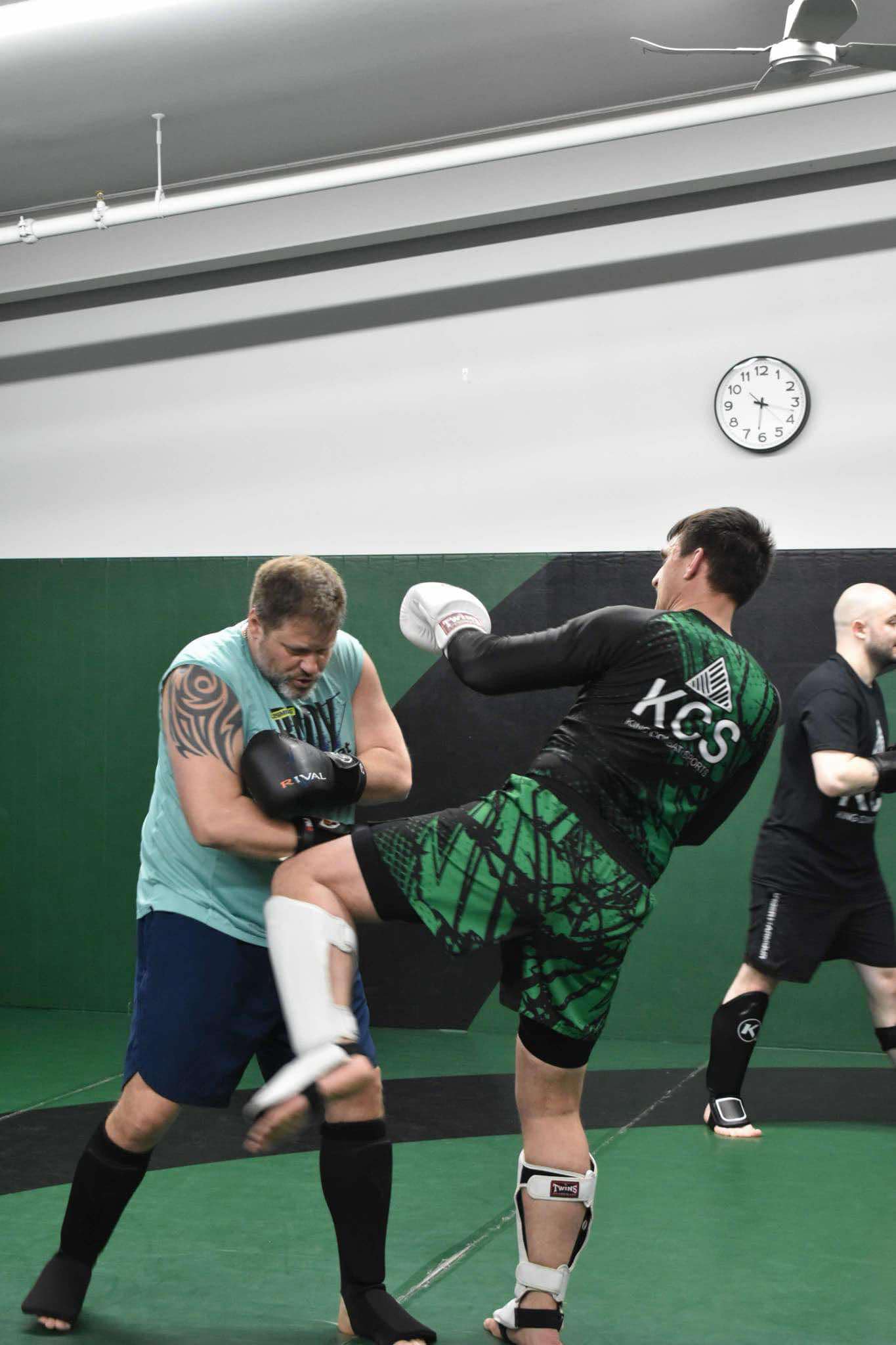 King Combat Sports students with boxing gloves on the mat