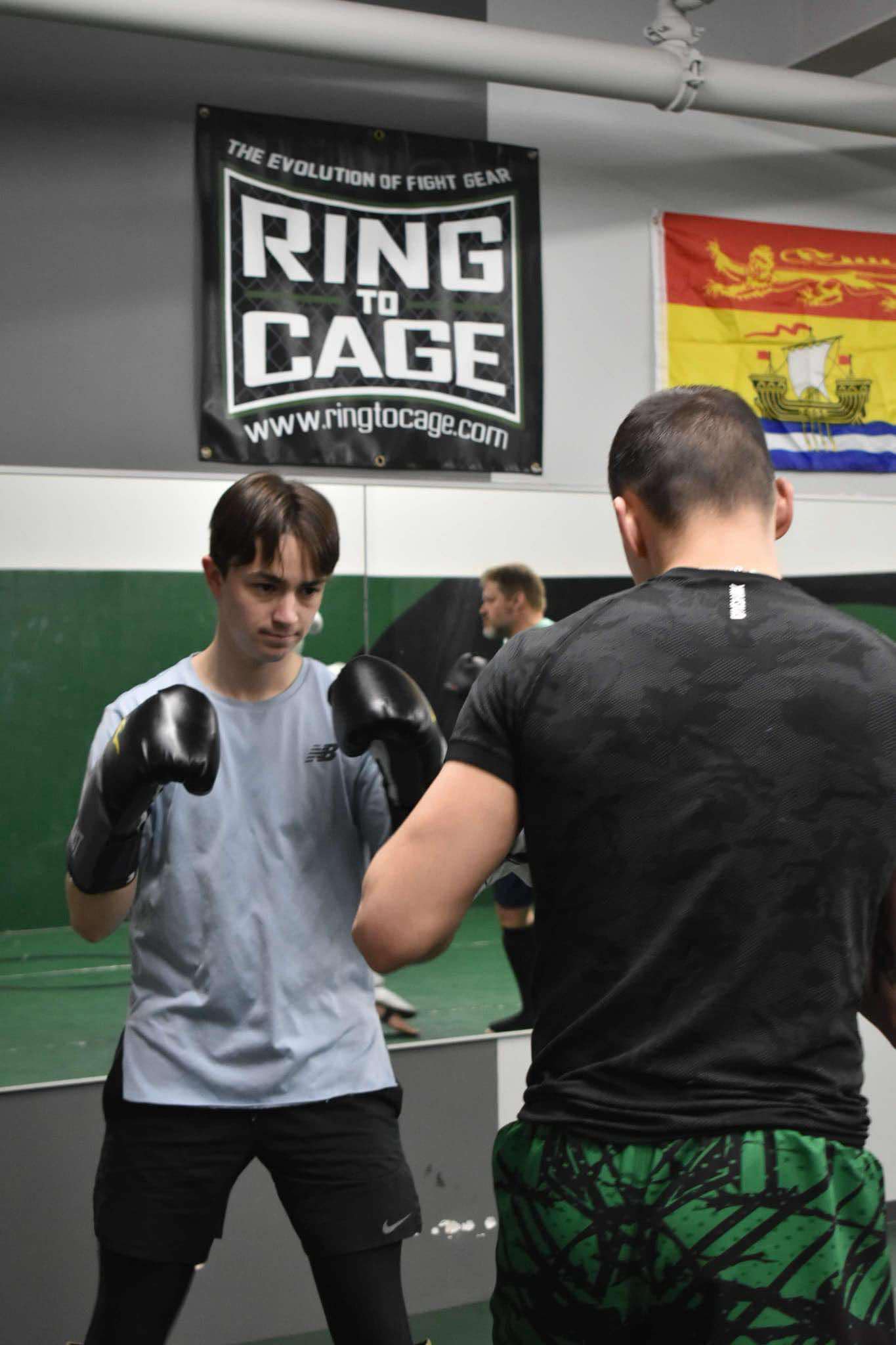 King Combat Sports students with boxing gloves on the mat