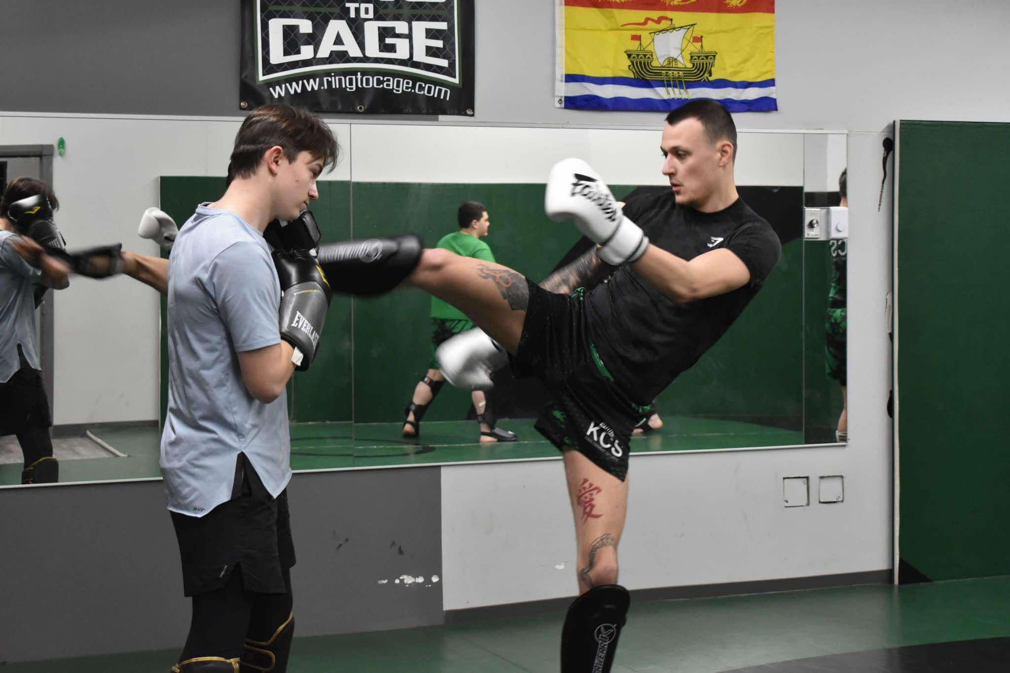 King Combat Sports students with boxing gloves on the mat