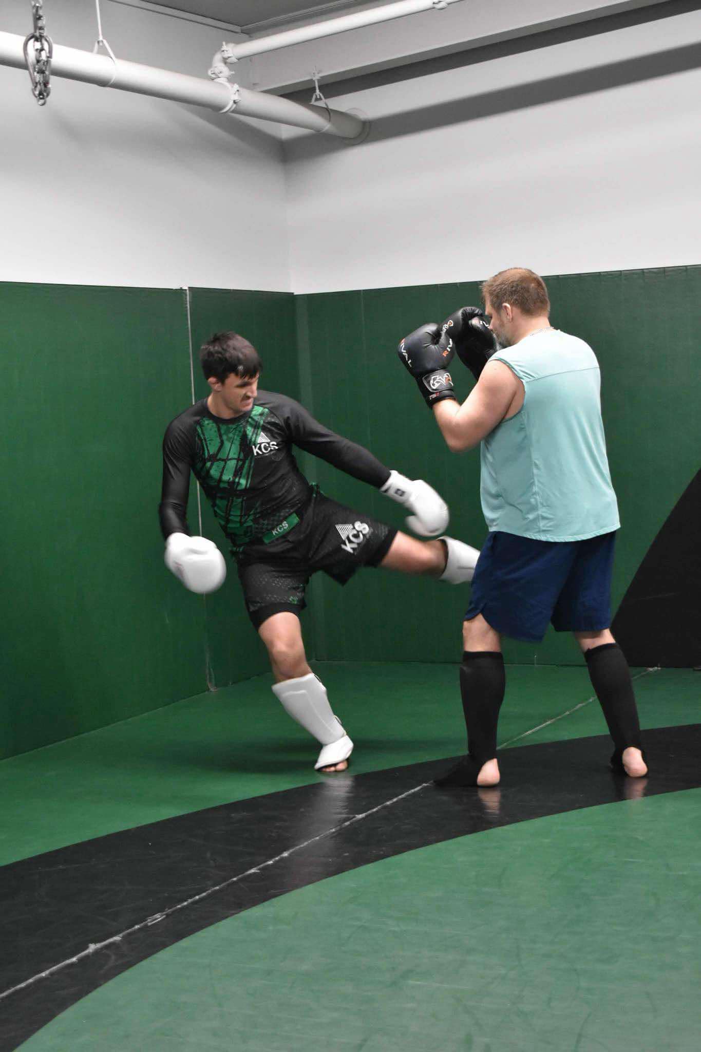King Combat Sports students with boxing gloves on the mat