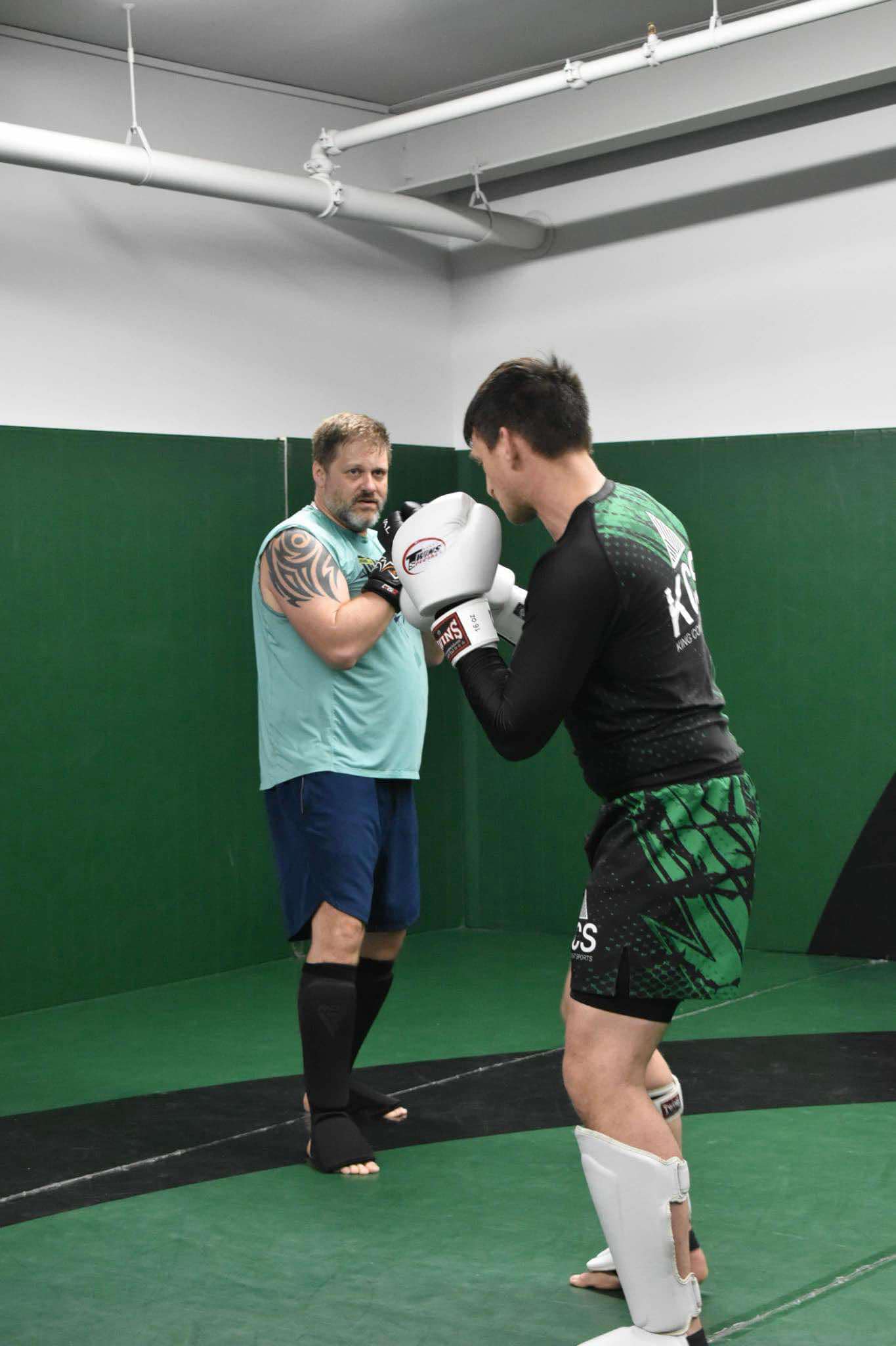 King Combat Sports students with boxing gloves on the mat